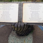 Book held in a carved hand